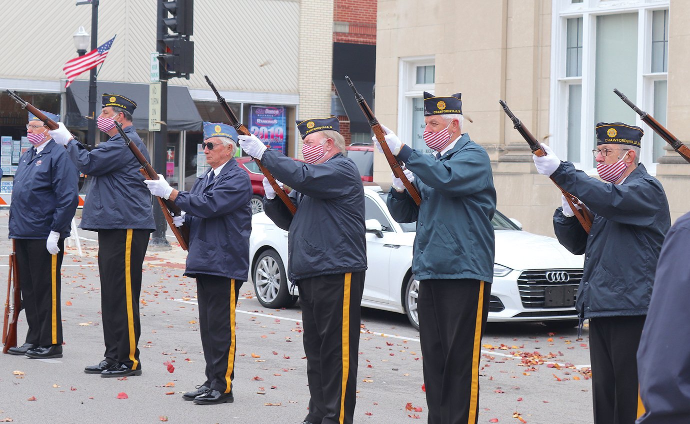 Veterans and members of Crawfordsville's Honor Guard perform the 21-Gun Salute on Green Street Wednesday at Canine Plaza.